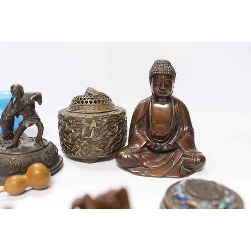 552 - A quantity of Chinese bronzes and wood carvings including stands, seated Buddha etc.