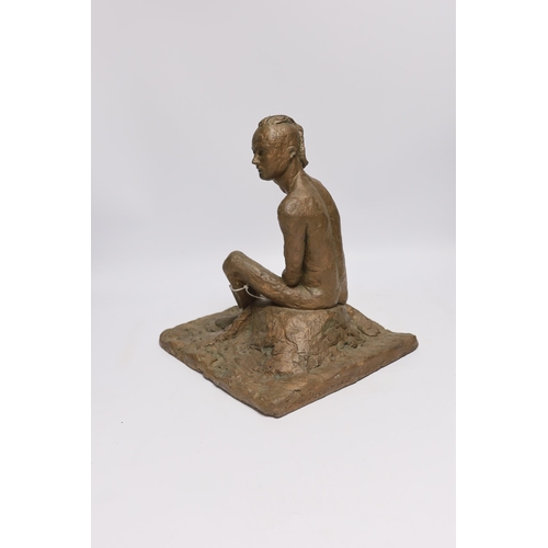 563 - An abstract bronzed resin sculpture of a kneeling man, 30cm