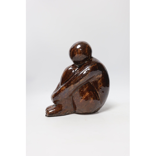 566 - A 20th century tenmoko glazed pottery figure of a seated figure, 22cm