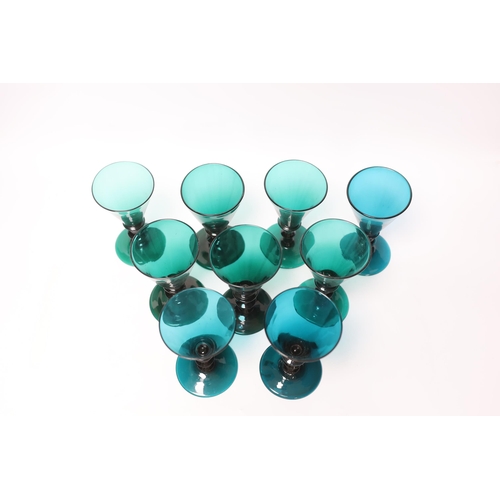 571 - Nine early 19th century green wine glasses, 14cm