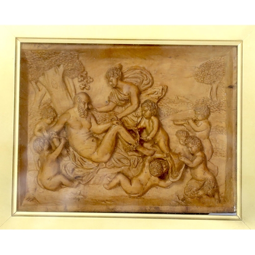 580 - A 19th century framed carved wood panel depicting Bacchanalians, 12x16cm