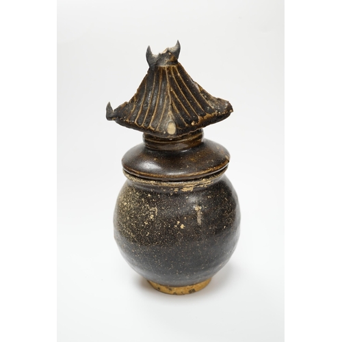 583 - A Khmer brown glazed jar and cover, Cambodia, 12th century, 18cm