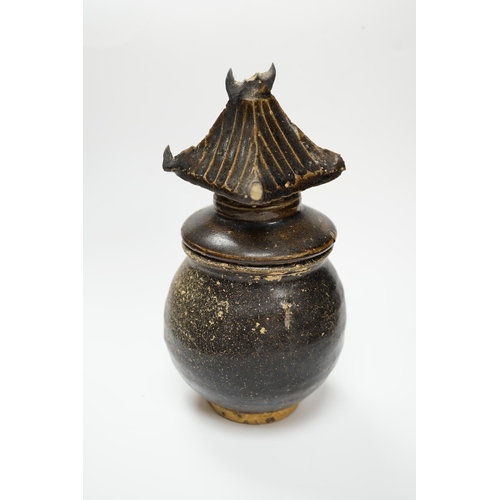 583 - A Khmer brown glazed jar and cover, Cambodia, 12th century, 18cm