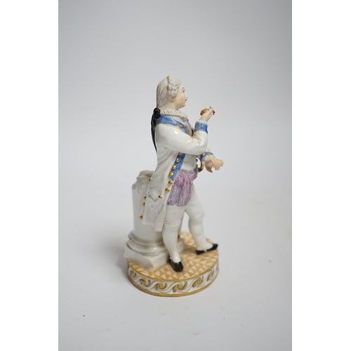 592 - A Meissen style porcelain figure of a soldier in dress uniform with sword and holding aloft a pocket... 