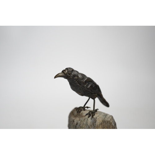 606 - A cold painted bronze crow, raised on a stone base, 10cm high