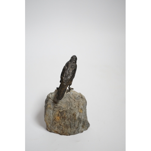 606 - A cold painted bronze crow, raised on a stone base, 10cm high