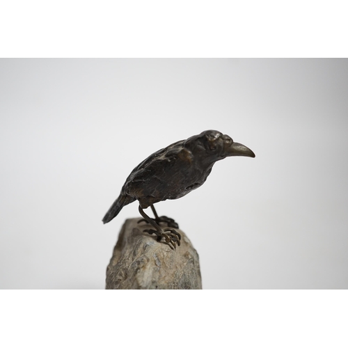 606 - A cold painted bronze crow, raised on a stone base, 10cm high