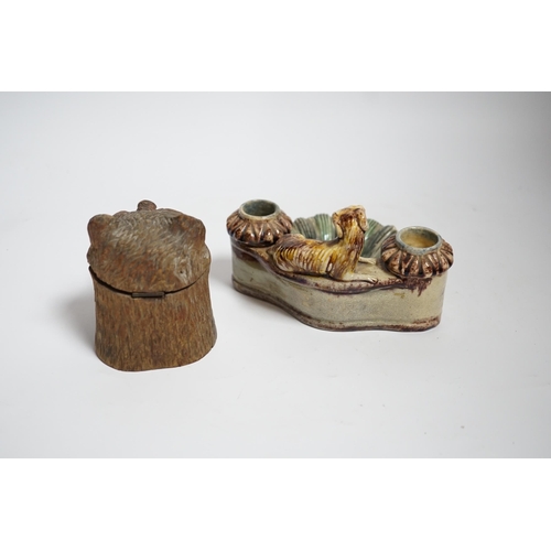 607 - A Black Forest carved bear inkwell and a majolica inkwell surmounted with a dog, largest 14cm wide... 