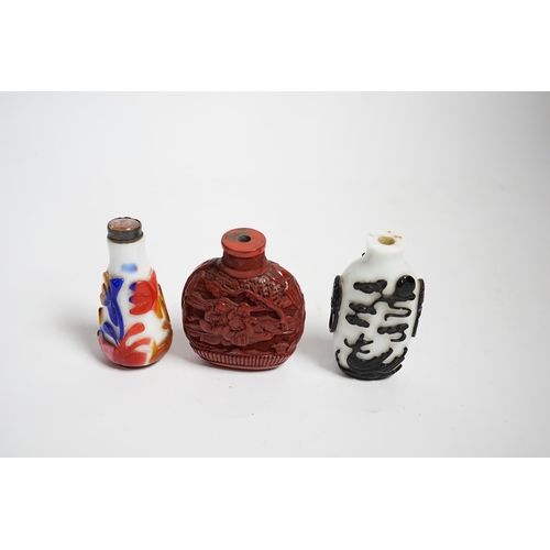 617 - Three Chinese snuff bottles including a 19th century cinnabar lacquer boys snuff bottle, largest 7... 