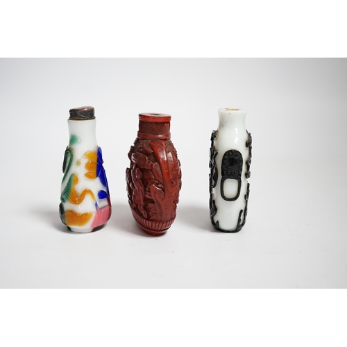 617 - Three Chinese snuff bottles including a 19th century cinnabar lacquer boys snuff bottle, largest 7... 