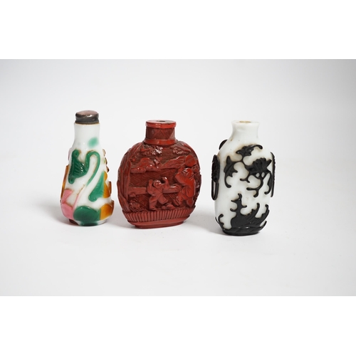 617 - Three Chinese snuff bottles including a 19th century cinnabar lacquer boys snuff bottle, largest 7... 