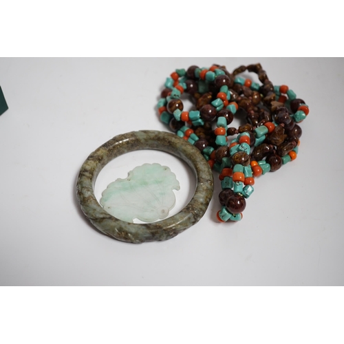 624 - Two Chinese hardstone necklaces, a carved bangle and a jade carving, bangle 8.5cm in diameter