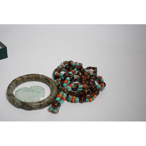 624 - Two Chinese hardstone necklaces, a carved bangle and a jade carving, bangle 8.5cm in diameter