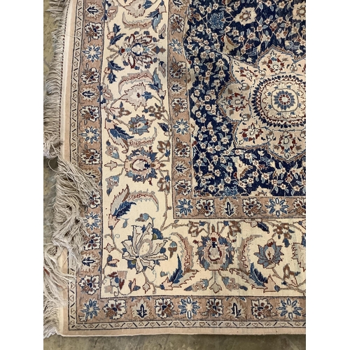 7 - A North West Persian blue and ivory ground carpet with floral borders, 250 x 168cm