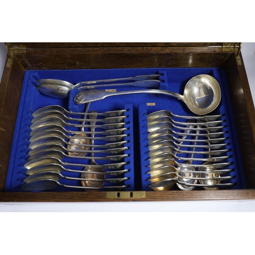 827 - A Victorian oak cased matched canteen of silver fiddle and shell pattern flatware, by John & Henry L... 