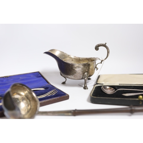 833 - A small group of silver items to include a George V sauceboat, London, 1934, a George III toddy ladl... 