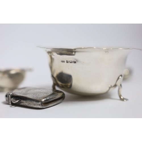 836 - A silver cigarette case, small silver quaich, silver bowl and silver matchbox sleeve.