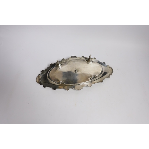 842 - A late Victorian silver navette shaped inkstand, with silver mounted cut glass well, on four reeded ... 