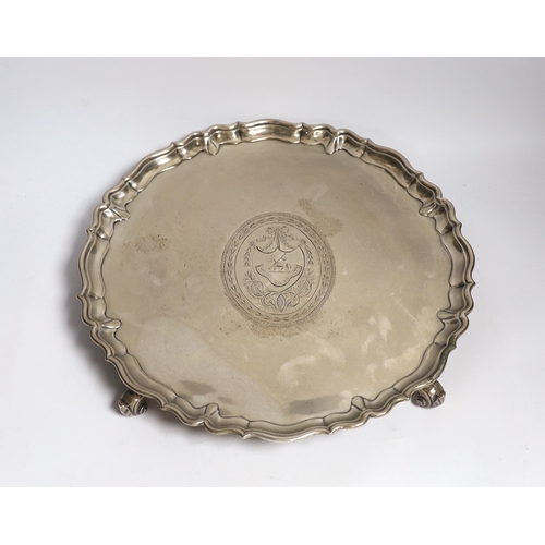 845 - A large George II silver shaped circular salver, with pie crust border and engraved armorial, on fou... 