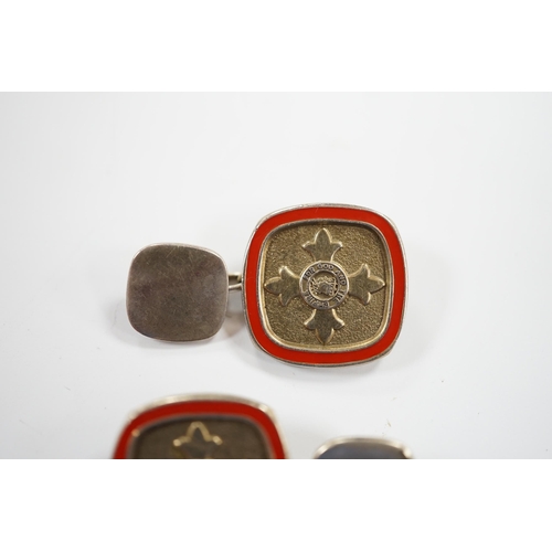 900 - A modern pair of silver and red enamel cufflinks, embossed with the Order of The British Empire, by ... 