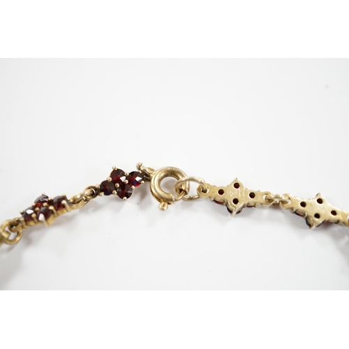 915 - An early 20th century gilt sterling and garnet cluster set drop necklace, 45cm.