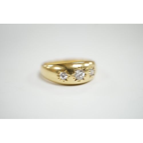 928 - A modern 18ct gold and gypsy set three stone diamond ring, size S, gross weight 7.9 grams.