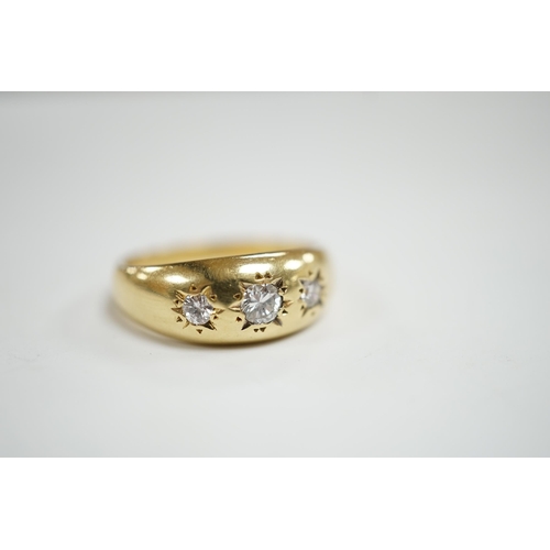 928 - A modern 18ct gold and gypsy set three stone diamond ring, size S, gross weight 7.9 grams.