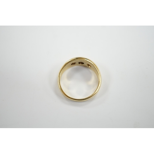 928 - A modern 18ct gold and gypsy set three stone diamond ring, size S, gross weight 7.9 grams.