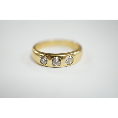 929 - A modern 18ct gold and gypsy set three stone diamond ring, size R, gross weight 7.6 grams.