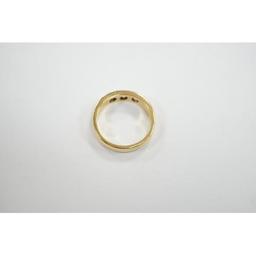 929 - A modern 18ct gold and gypsy set three stone diamond ring, size R, gross weight 7.6 grams.