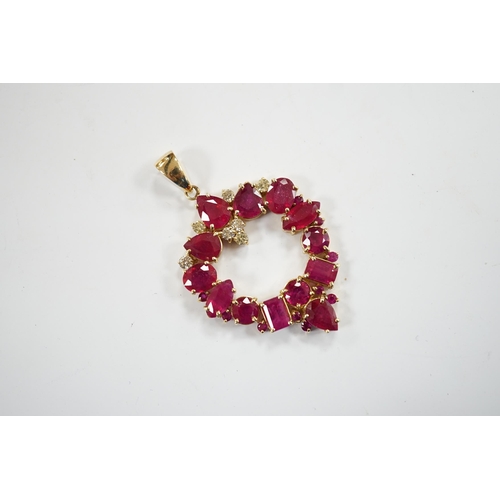 941 - A modern 14k, ruby(treated) and diamond cluster set open work pendant, overall 52mm, gross weight 10... 