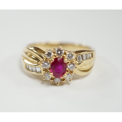 949 - A modern 14k, ruby and diamond set oval cluster dress ring, with diamond chip set shoulders, size P,... 