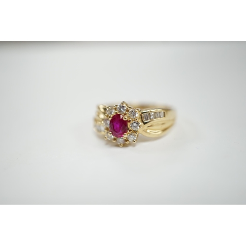 949 - A modern 14k, ruby and diamond set oval cluster dress ring, with diamond chip set shoulders, size P,... 