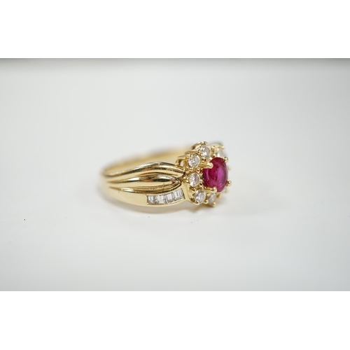 949 - A modern 14k, ruby and diamond set oval cluster dress ring, with diamond chip set shoulders, size P,... 