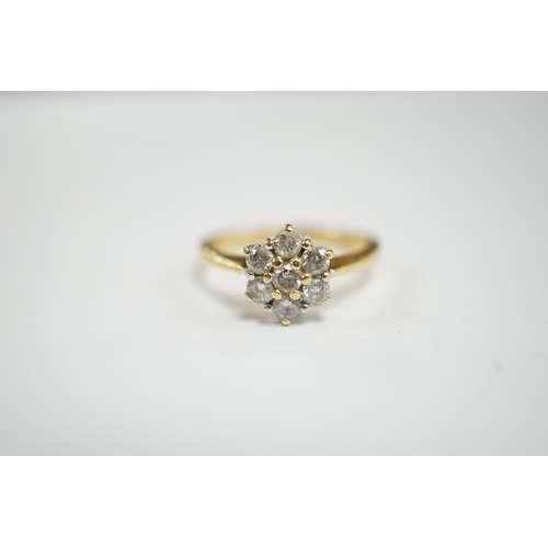 952 - A modern 18ct gold and seven stone diamond cluster set flower head ring, size N, gross weight  3.6 g... 