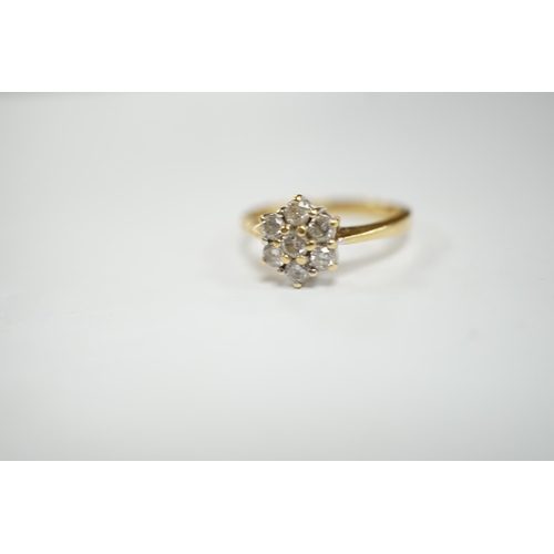 952 - A modern 18ct gold and seven stone diamond cluster set flower head ring, size N, gross weight  3.6 g... 