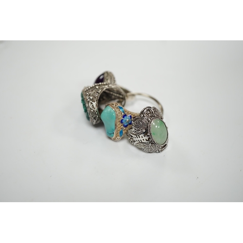 963 - Four assorted Chinese white metal filigree and gem set rings, including turquoise and amethyst.... 