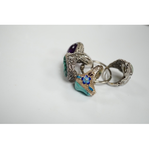 963 - Four assorted Chinese white metal filigree and gem set rings, including turquoise and amethyst.... 