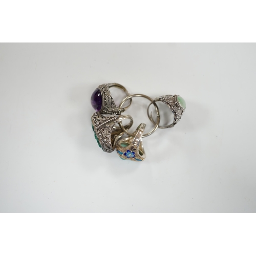 963 - Four assorted Chinese white metal filigree and gem set rings, including turquoise and amethyst.... 