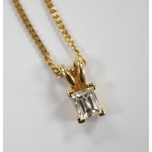 973 - A modern 18ct gold and single stone fancy rectangular cut diamond set pendant, 9mm, on an 18ct gold ... 