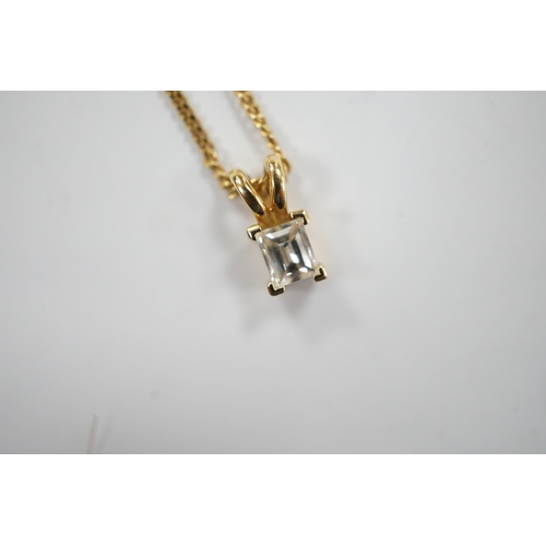 973 - A modern 18ct gold and single stone fancy rectangular cut diamond set pendant, 9mm, on an 18ct gold ... 