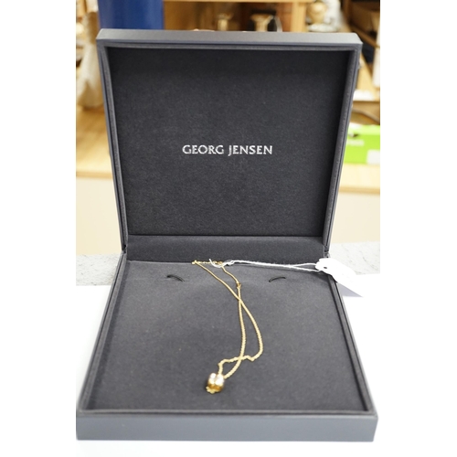 976 - A modern Georg Jensen two colour 18ct gold barrel pendant, 10mm, on a Georg Jensen 18ct gold fine li... 