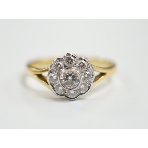 983 - A modern 18ct gold and nine stone diamond set flower head cluster ring, size M, gross weight  3 gram... 