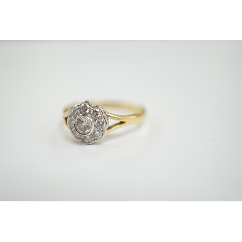 983 - A modern 18ct gold and nine stone diamond set flower head cluster ring, size M, gross weight  3 gram... 