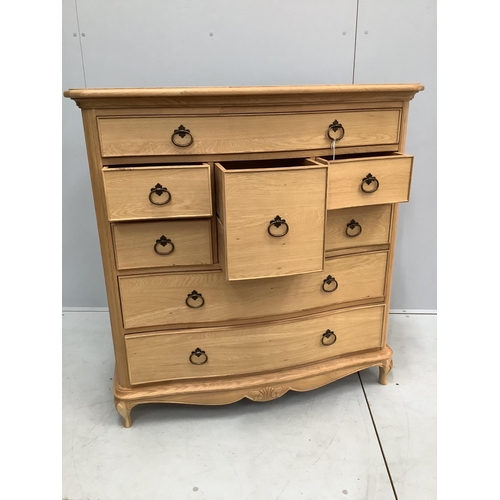 127 - A Willis and Gambier Charlotte oak serpentine chest of eight drawers, width 108cm, depth 53cm, heigh... 