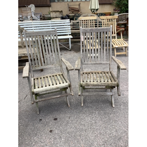 177 - A weathered teak rectangular folding garden table, width 157cm and four folding chairs