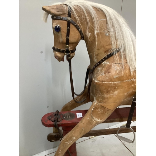 194 - An early 20th century carved wood rocking horse on stand (a.f.), 117cm high, base of stand 146 wide... 