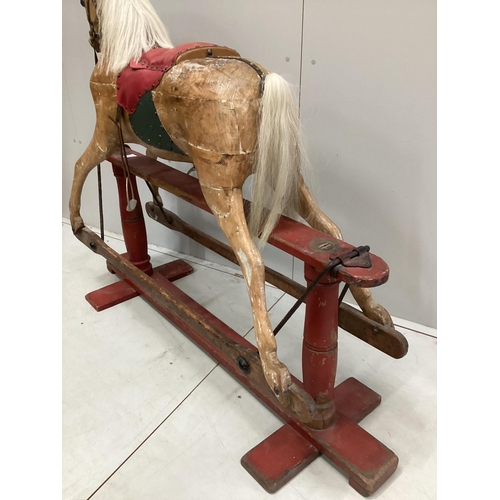 194 - An early 20th century carved wood rocking horse on stand (a.f.), 117cm high, base of stand 146 wide... 