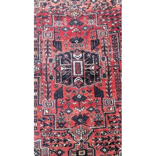 201 - A Persian Shiraz carpet, 300 x 210cm