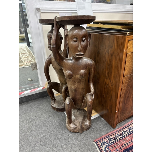 225 - A pair of Sarawak carved hardwood figures. height 85cm